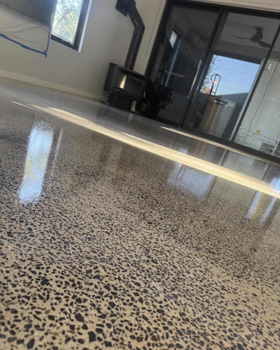 Polished aggregate concrete floor running through a residential living space